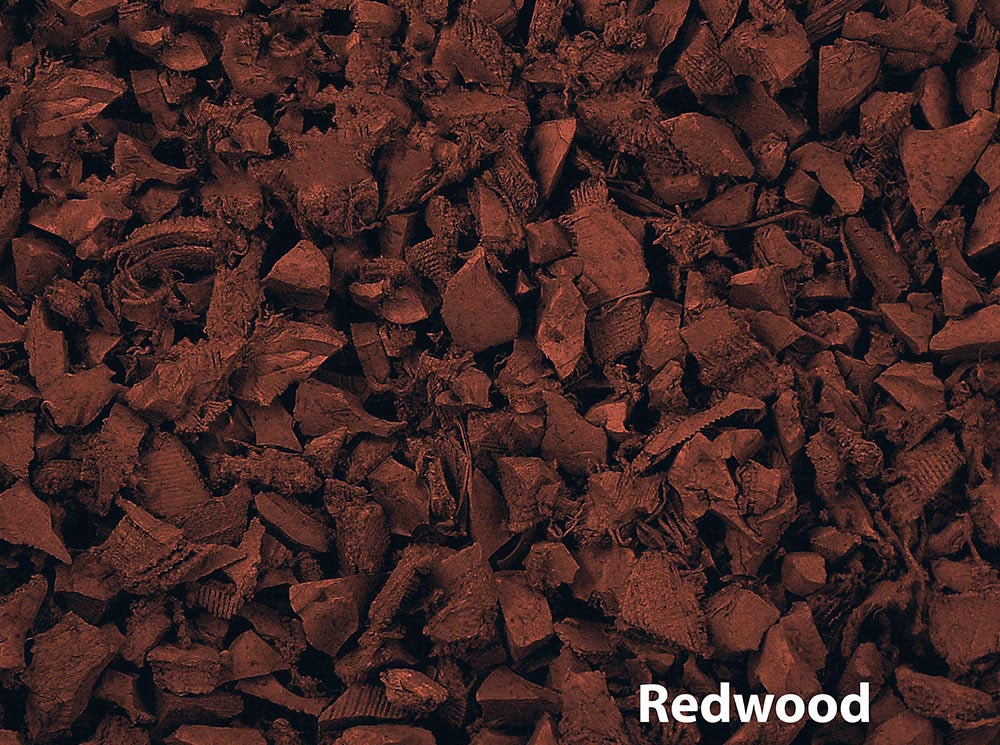 Overhead close-up of textured red rubber playground mulch pieces with irregular shapes and vibrant color.