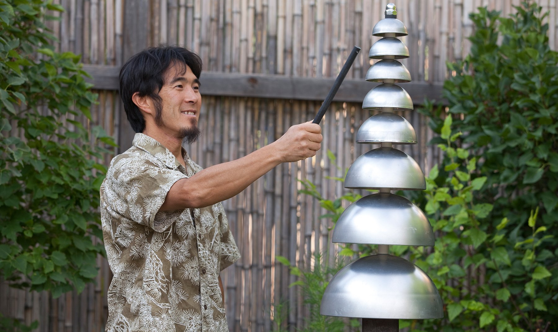 Pagoda Bells Outdoor Musical Park Instrument with vertical silver aluminum bells in garden setting, designed for outdoor musical play.