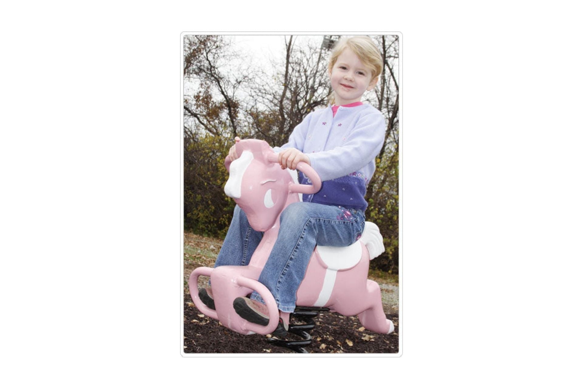Pink Pony Easy Rider spring rider with white accents, child seated outdoors on durable pink pony playground toy