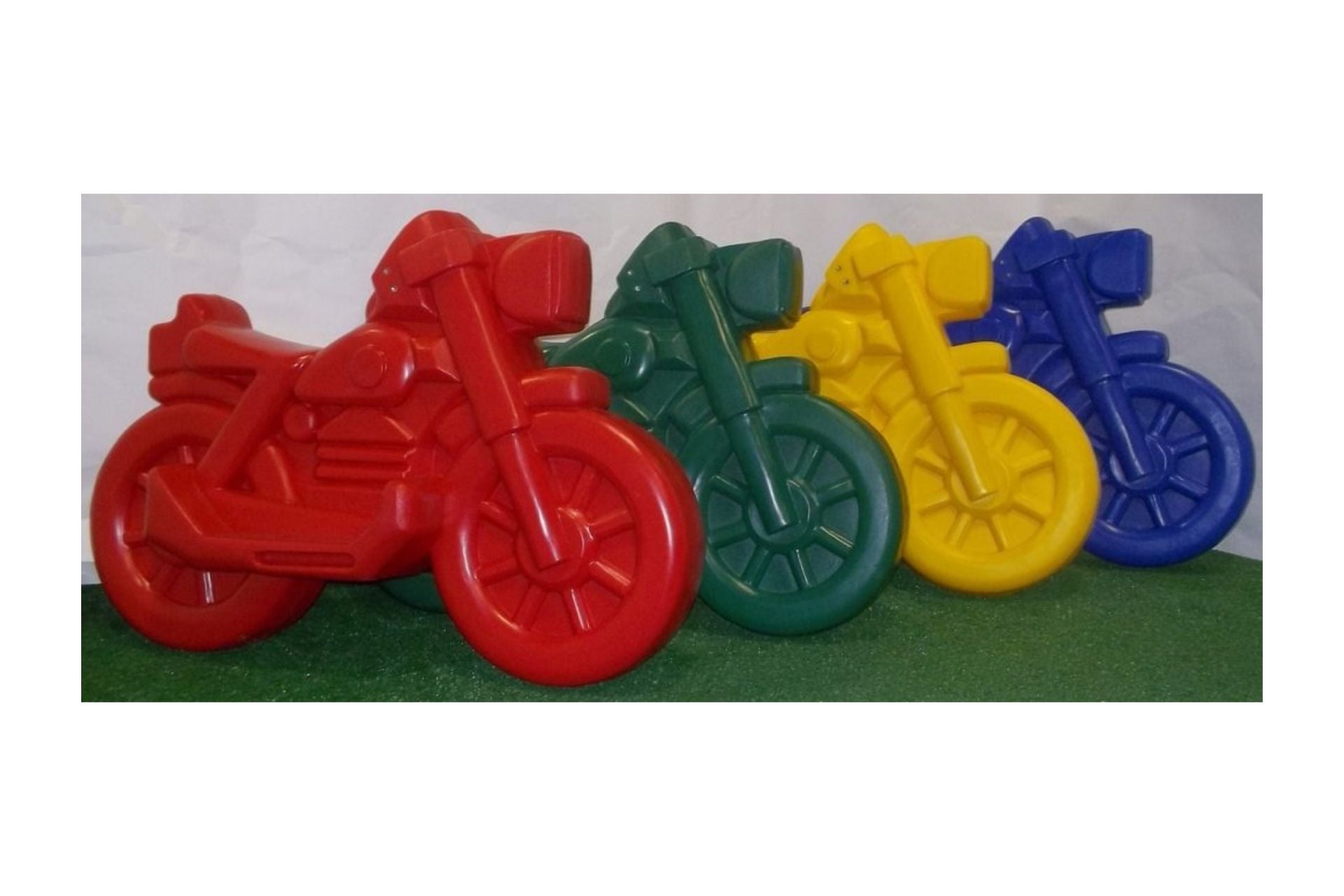 Roto Molded Spring Ride Motorcycle in red, green, yellow, and blue durable polyethylene with smooth rounded design and enclosed rubber spring