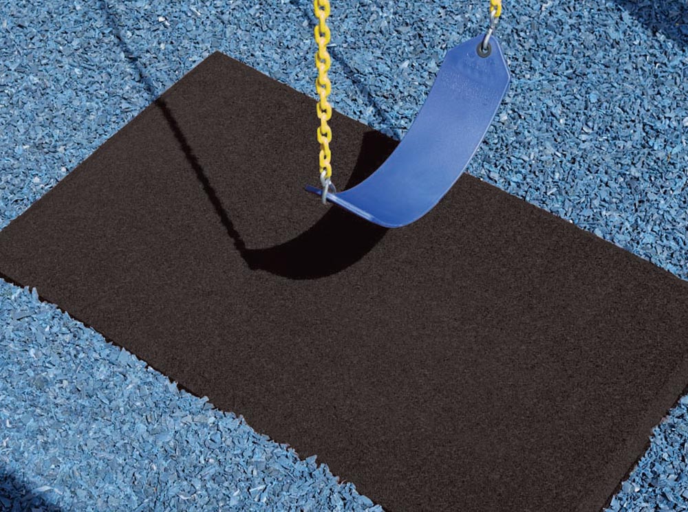 Durable black recycled rubber playground mat with beveled edge beneath blue swing with yellow chains on blue mulch surface