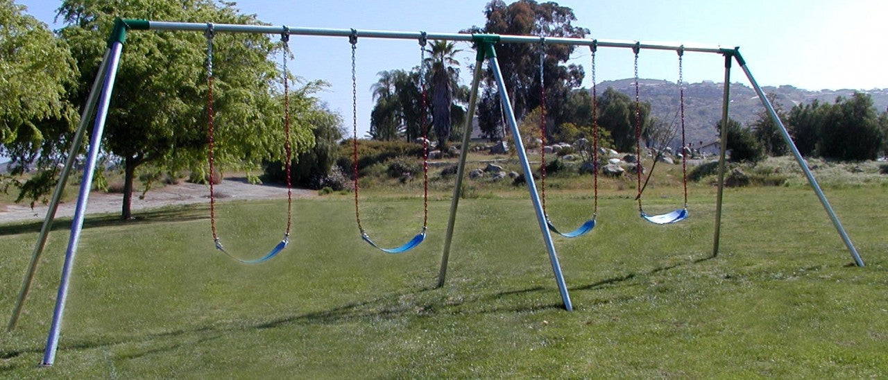 Outdoor metal swing set with two bays, four blue plastic seats hanging from red chains on grass