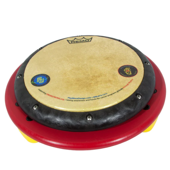 Overhead view of a red and yellow children's drum table with a tunable REMO drum-head and colorful logos on the drum surface