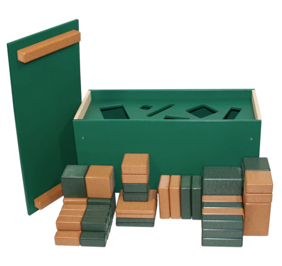 Green and tan eco-friendly geometric blocks arranged in front of a green shape sorter box with cutouts for sorting shapes