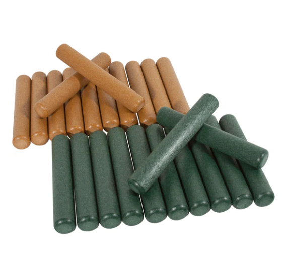 Green and brown recycled plastic rhythm claves arranged in two groups with some stacked on top
