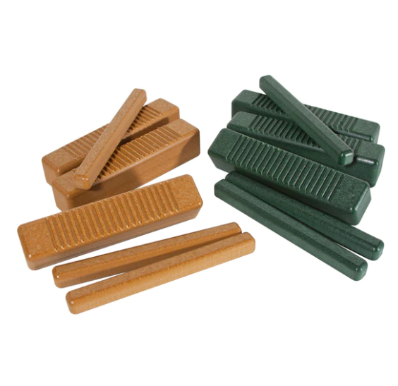 Green and brown recycled plastic percussion instruments including ridged tone blocks, guiros, and claves arranged for group play
