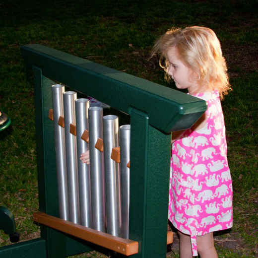 Child playing outdoor musical chime unit with six aluminum tubes and green recycled plastic frame