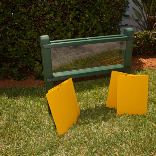 Green outdoor planter with clear front and back windows and yellow sliding panels for observing root growth in soil