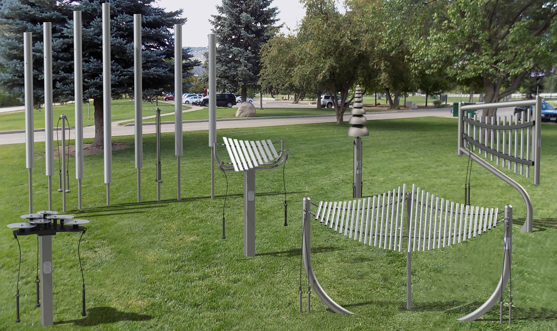 Outdoor musical park instruments including chimes, xylophone, cymbals, and bells arranged on grass in a park setting