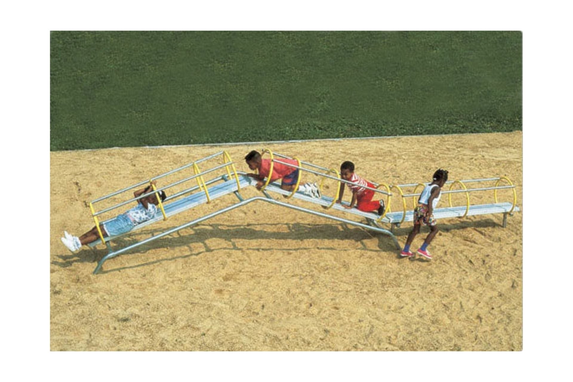 Sensori Tunnel Climber with children crawling and climbing through bright yellow-ringed metal tunnels on sandy playground