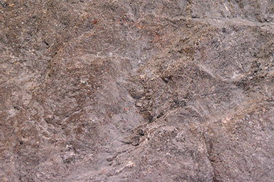 Textured slate grey climbing boulder with natural rock-like features for outdoor play and motor skill development