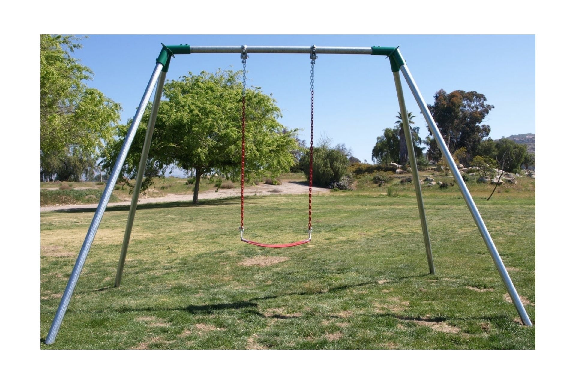 Standard 8 Foot High Swing Set with single red swing seat and metal frame in grassy park setting