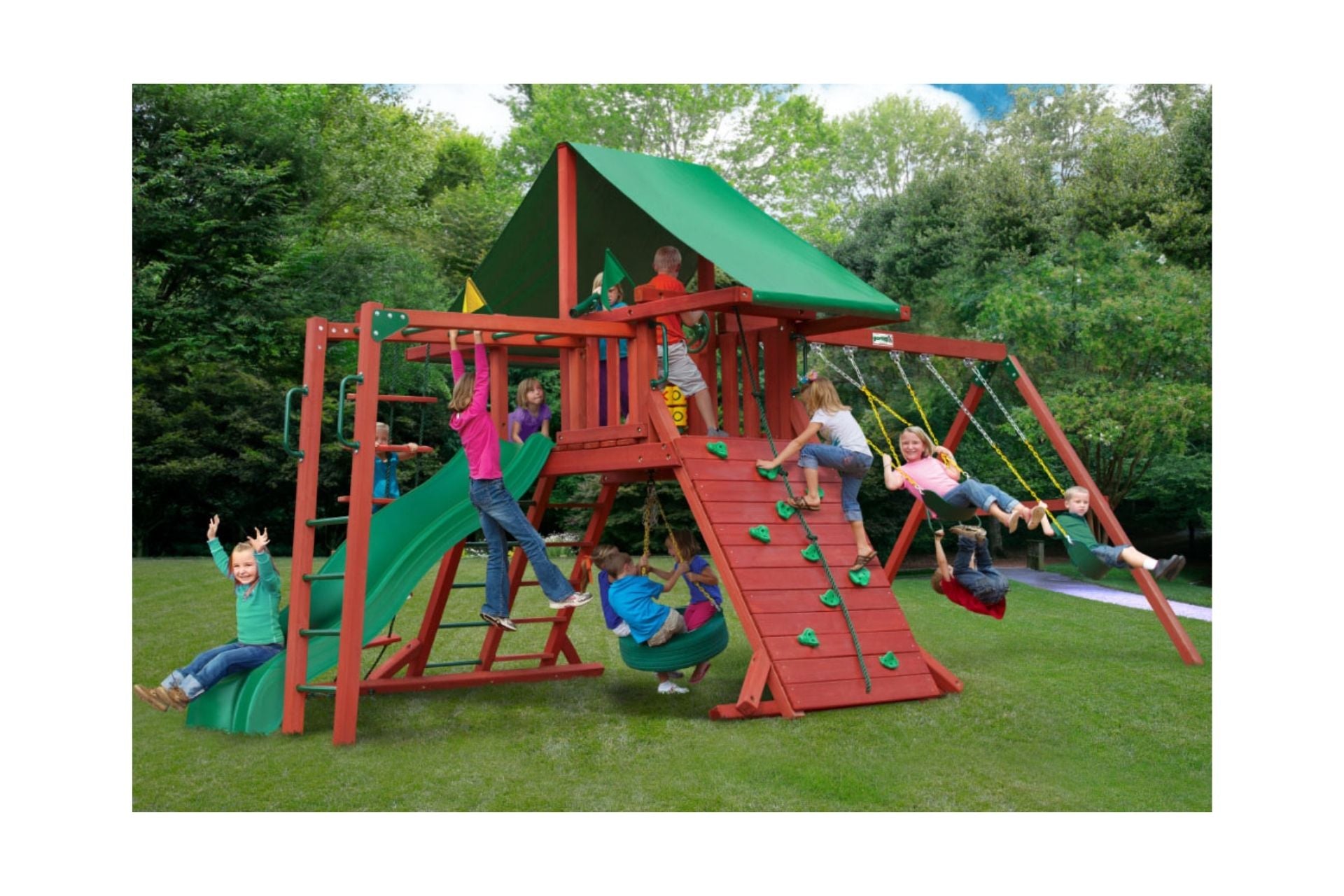 Sun Valley II Wooden Swing Set With Monkey Bars in redwood finish, featuring green canopy, slide, climbing wall, swings, and tire swing in backyard.