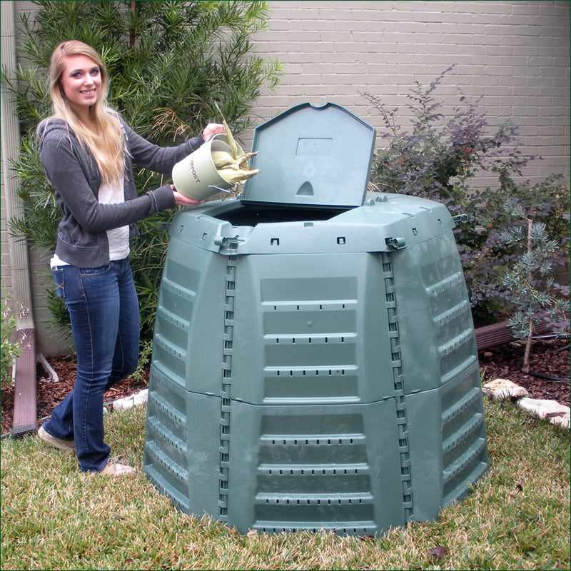 Thermo Star 1000 Compost Bin in green with insulated Thermolen walls, outdoor setting, woman adding organic waste