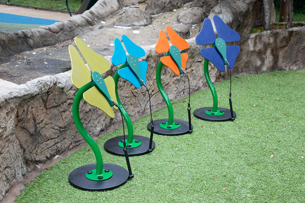 Toddler Flowers Outdoor Musical Park Instrument with colorful bell-shaped flower notes and black mallets on green play surface