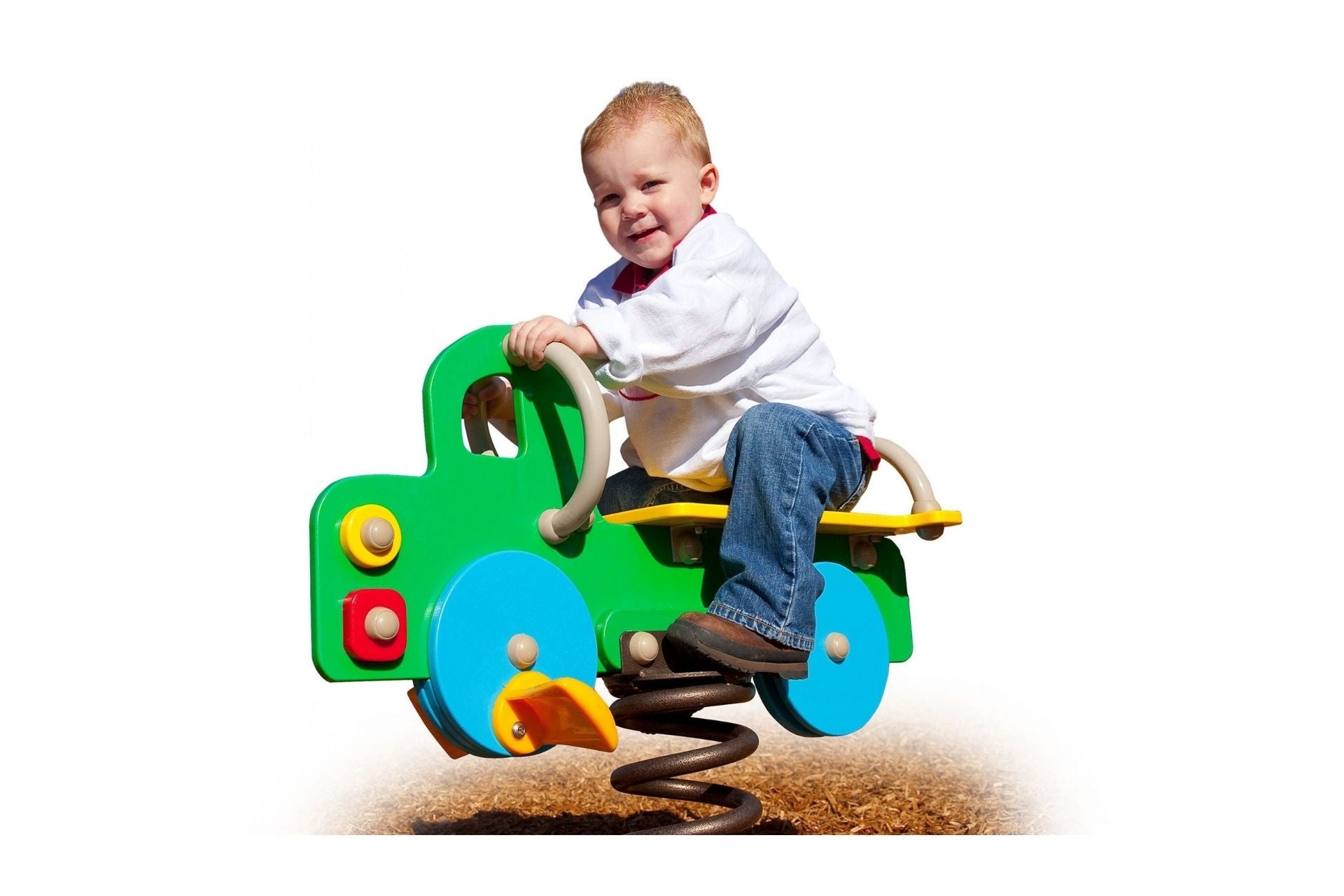 A child playing on a colorful truck-shaped spring rider in a playground setting.