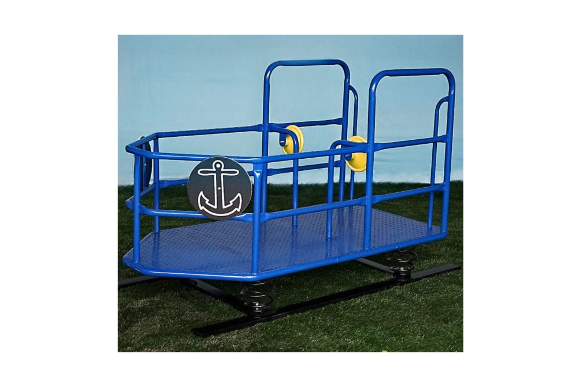 Blue metal tug boat spring rider with black anchor emblem and two yellow plastic steering wheels on grass