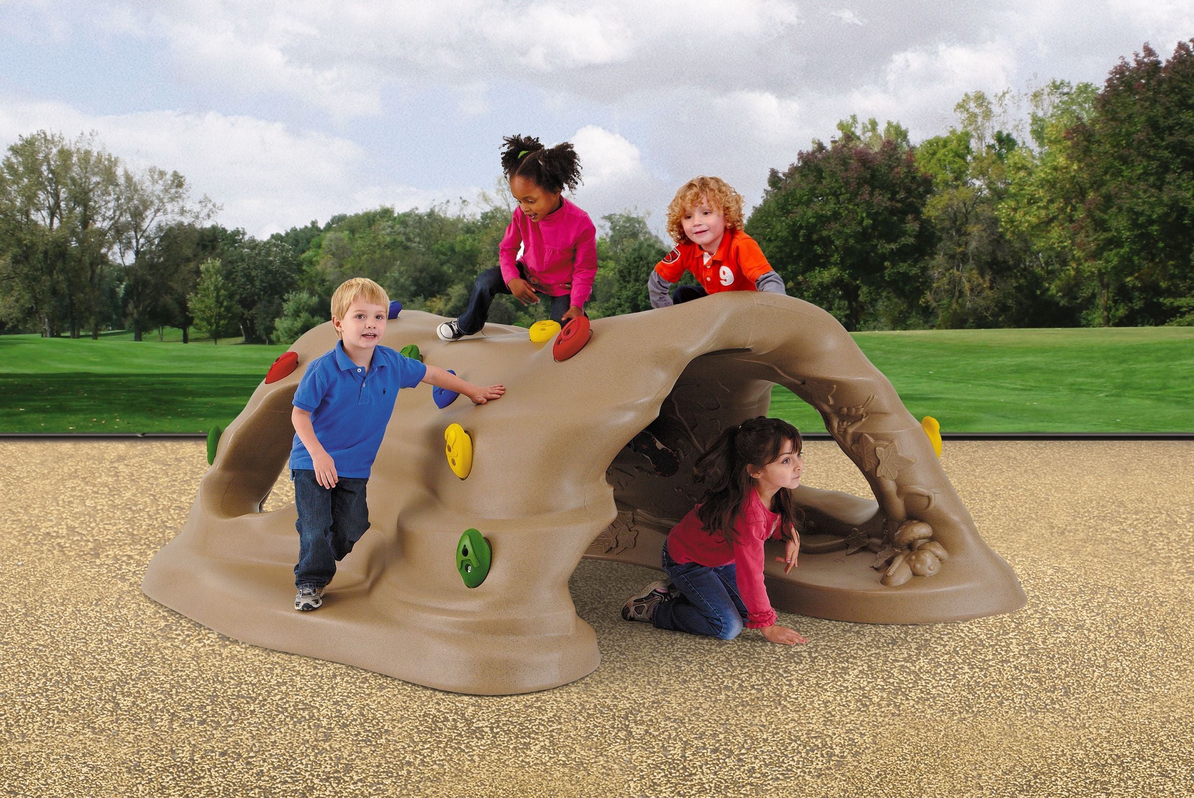 Children climbing on a tan, nature-themed play structure with colorful grips and large openings in an outdoor playground