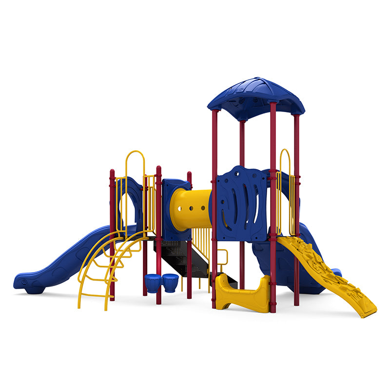 Colorful playground structure with double and single slides, rock climber, crawl tunnel, bongo drums, and saddle seat in blue, yellow, and red.