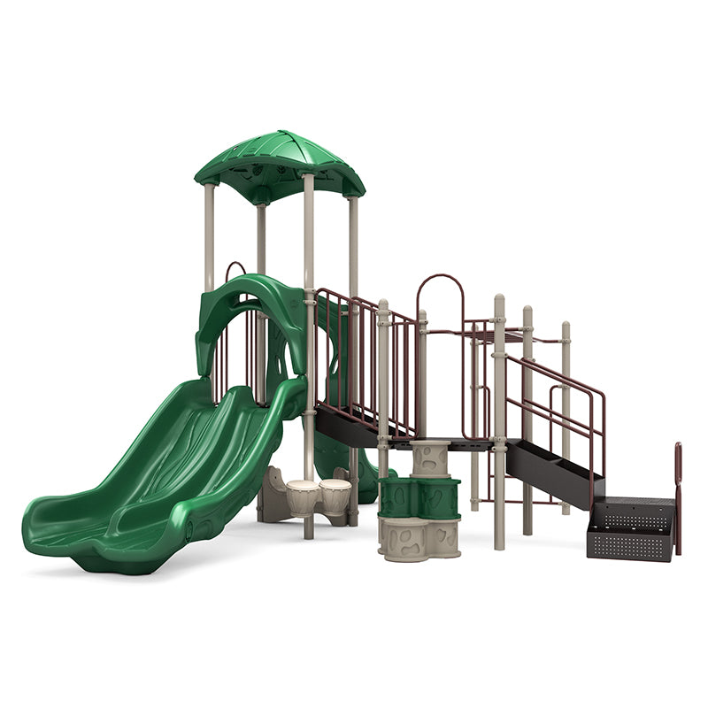 Playground structure with neutral leaf-shaped roof, double green slides, climbing ladder, bongos, and activity panels.