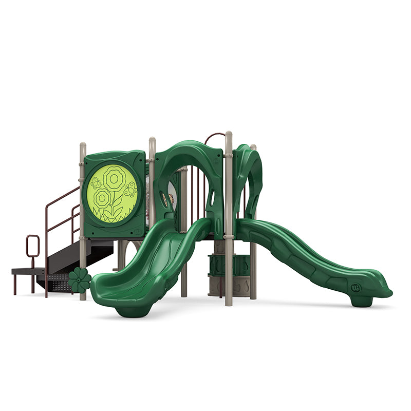 Sunny Days Playground neutral play system with two green slides, trunk climber, stairs, ADA transfer station, and activity panels.