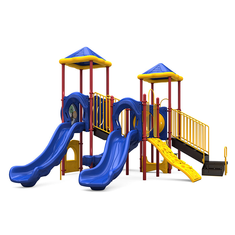 Colorful playground structure with blue double slides, yellow climbing wall, crawl tunnel, and pyramid roofs