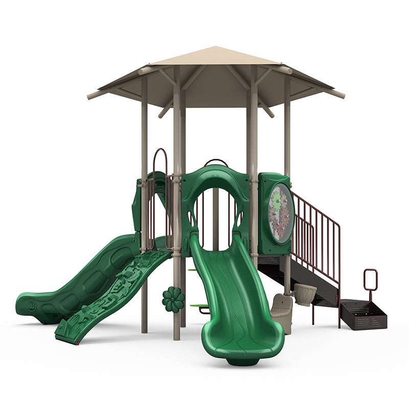 Playground structure with neutral shade roof, green double and single slides, climbing wall, gears panel, and musical bongo.