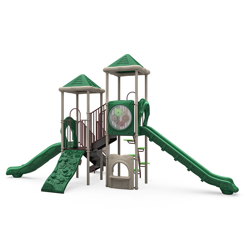 Green and beige playground structure with two slides, climbing wall, gear panel, leaf step climber, and musical drums.