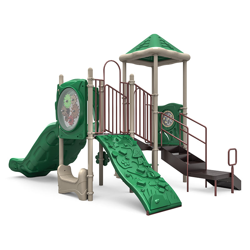 Outdoor playground structure with green roof, double slide, rock climber, gears panel, stairs with handrails, and interactive play elements