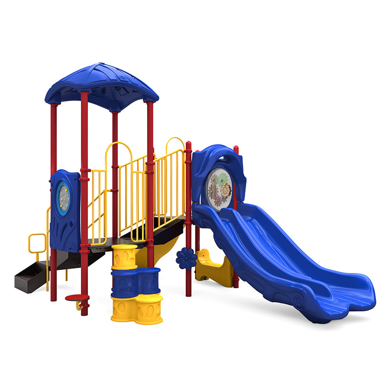 Colorful playground structure with double blue slides, yellow railings, red posts, climbing elements, and interactive panels including gears and maze features.