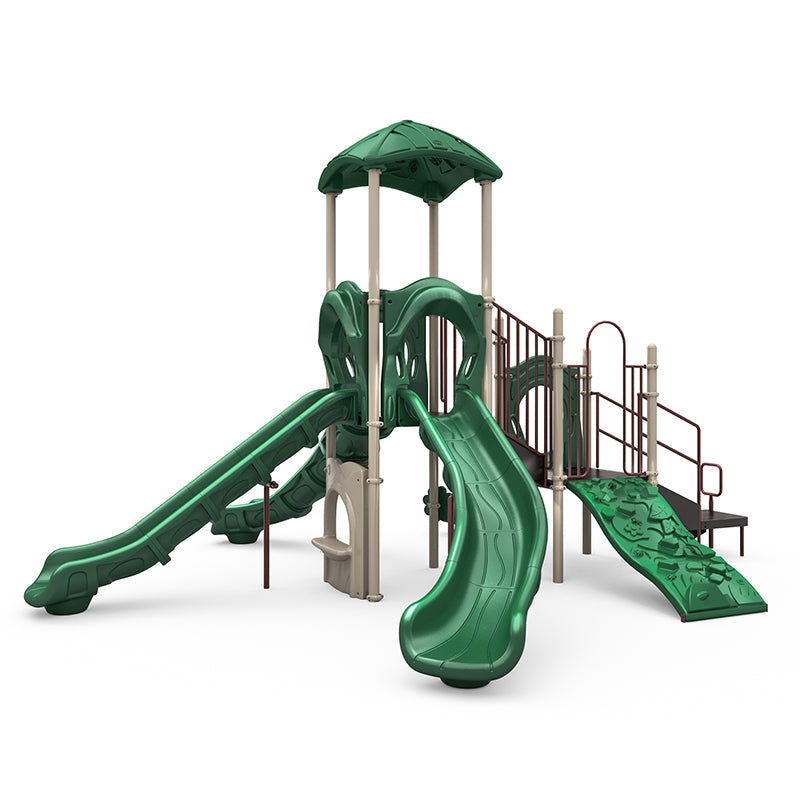 Green and beige playground structure with four slides, rock climbing wall, bongos, and leaf-shaped canopy roof