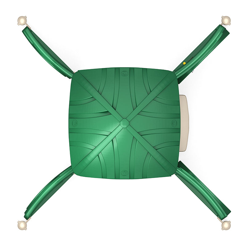 Overhead view of a green playground structure with four slides extending from a central platform and interactive play panels