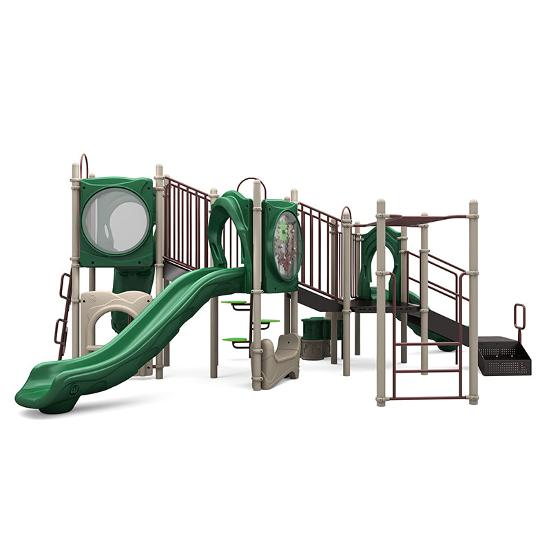 Outdoor playground structure with green slides, multiple climbing elements, interactive gear panel, and platforms