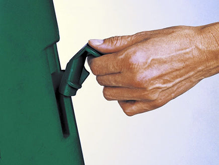 Hand adjusting sliding lock latch on green durable outdoor compost bin with ventilated side panels and hinged lid
