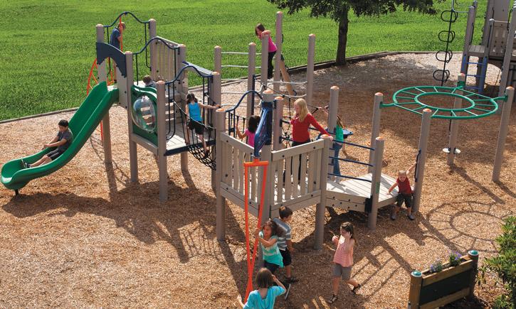 Outdoor ADA-accessible playground with slide, rope net climbers, overhead ring, ramp, and children playing