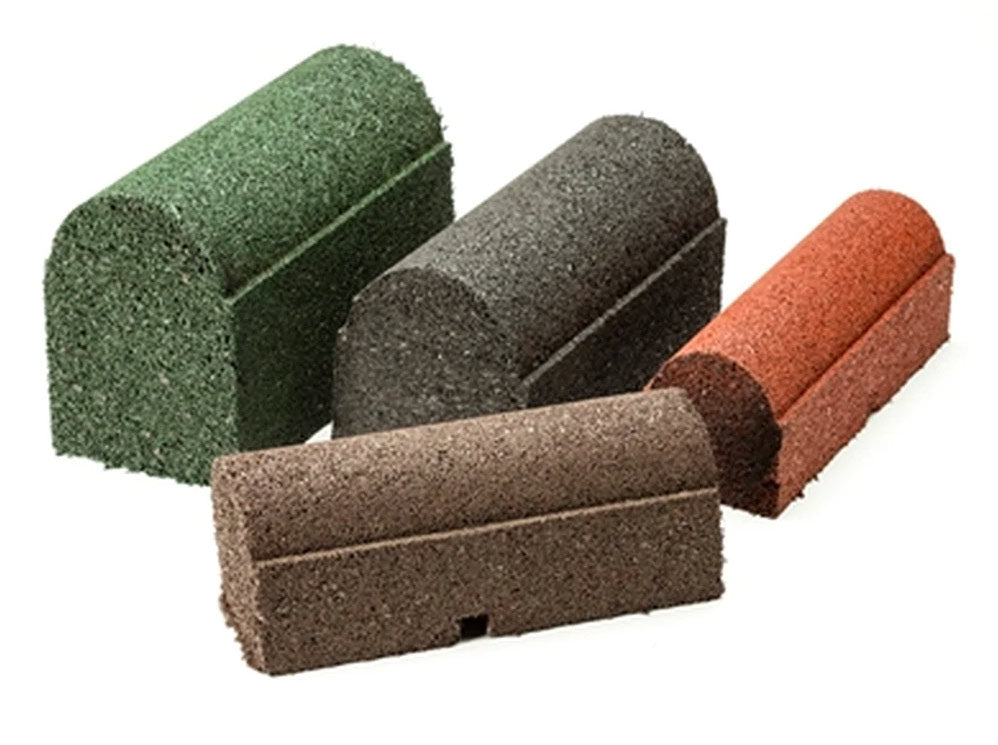 Four rubber playground border timbers in earthtone, forest green, classic black, and redwood with rounded tops and drainage ports