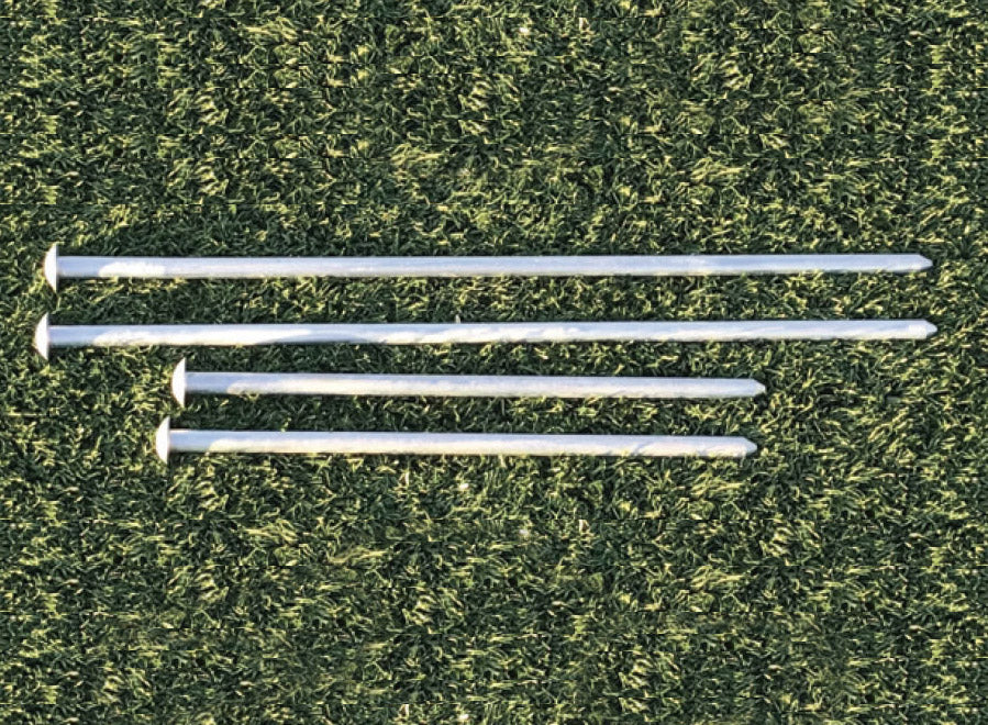 APS Playground Border Spike metal spikes in varying lengths arranged on grass for securing playground borders