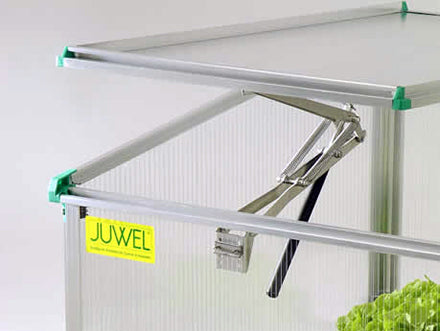 Compact cold frame greenhouse with clear twin-wall polycarbonate panels, metal frame, and adjustable roof vents for airflow control.