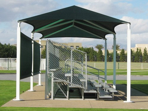 Rectangular hip roof shade structure with six white posts covering metal bleachers in outdoor park setting