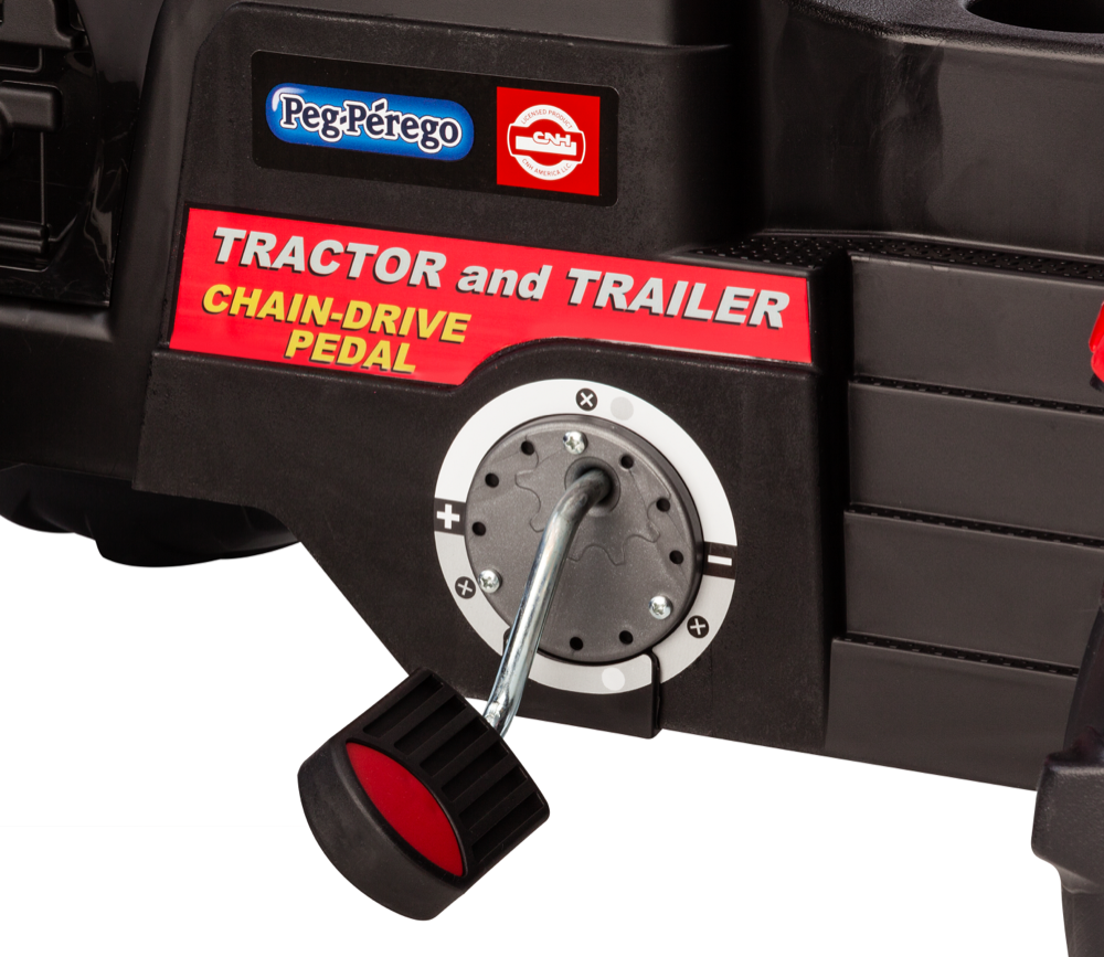 Black pedal with red center on a children's pedal and chain drive tractor and trailer toy
