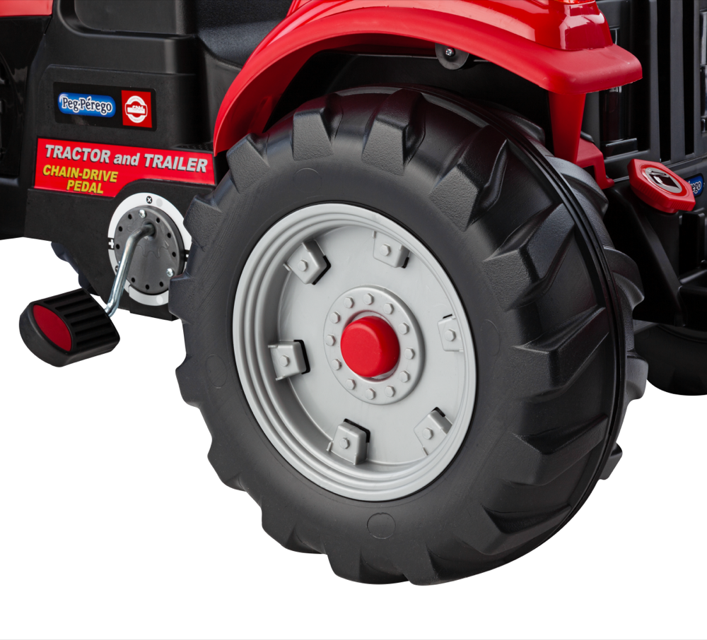 Red pedal ride-on tractor wheel with heavy-duty tread and attached pedal mechanism for outdoor play and exercise.