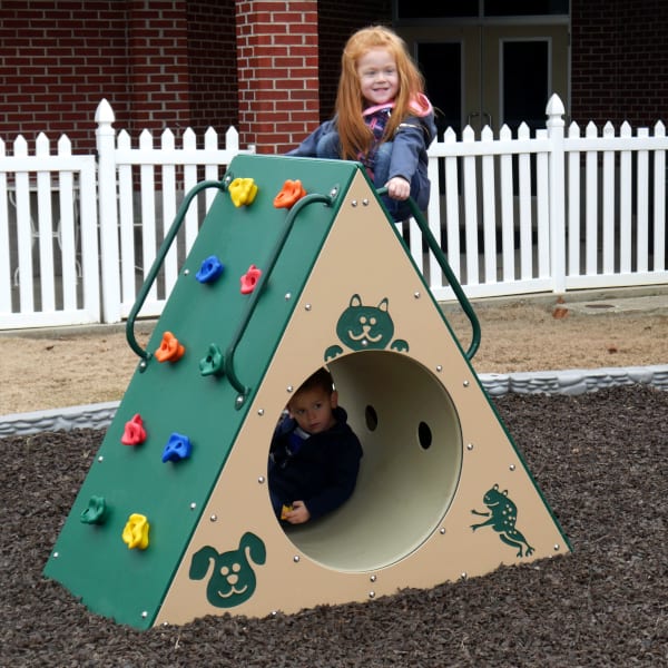 Triangular outdoor climbing wall with colorful handholds and an animal-themed tunnel, children playing actively.