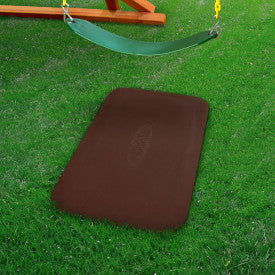 Durable brown rubber ground protection mat under green swing on grass preventing soil wear and mud buildup