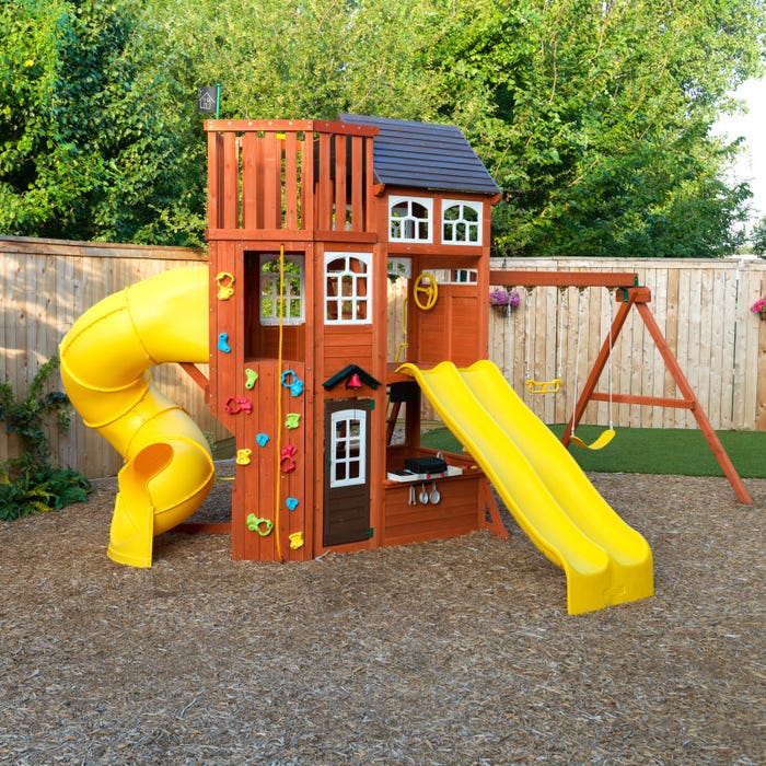 Lookout Extreme Wooden Swing and Play Set with triple yellow slides, climbing wall, playhouse, swings, and lookout deck in backyard setting