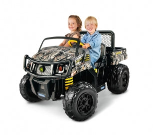 Child-sized John Deere Gator XUV ride-on in Realtree camo with large tires, brush guard, and two children seated