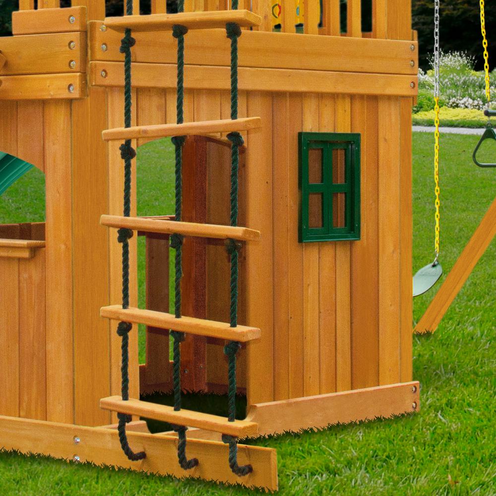 Cedar wooden playset with rope ladder, green vinyl canopy, arched entry, large window, and attached swings on grass