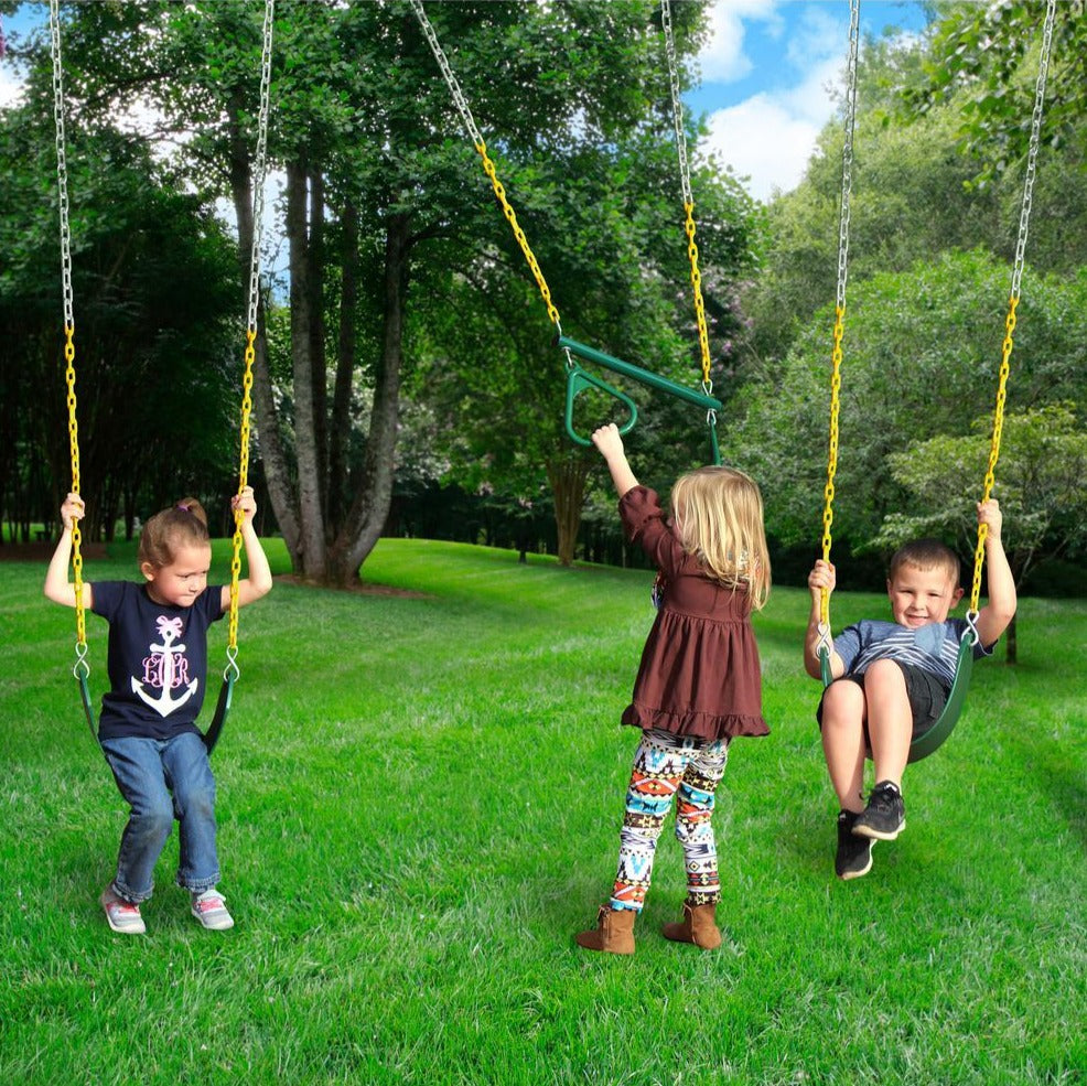 Three children playing on green and yellow belt swings in a grassy backyard with trees
