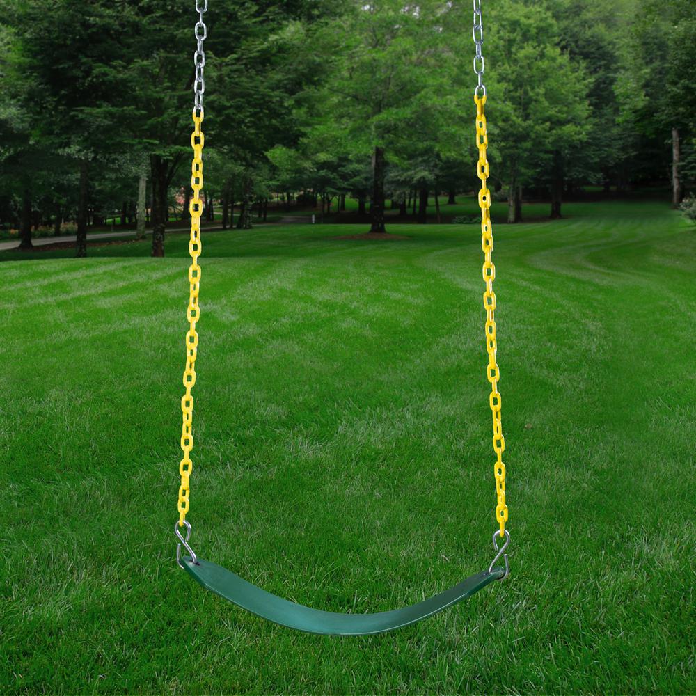 Green belt swing with yellow plastic-coated chains hanging in a grassy backyard surrounded by trees
