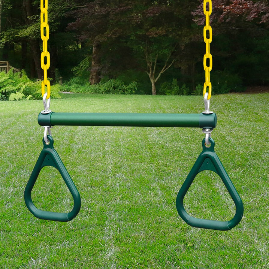 Green trapeze bar with two triangular handles hanging from yellow chains on a wooden swing set over grass