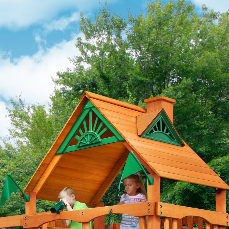 Amber-stained wooden playset platform with green vinyl canopy and two children playing on deck
